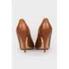 Caramel colored leather pumps