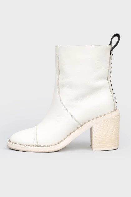 White boots with metal spikes