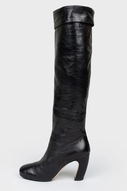Black leather boots with curved heels