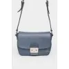 Dark blue leather bag with a metal clasp