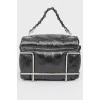 Black leather handbag with a metal base