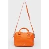 Bright orange leather bag with a zipper