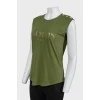 Khaki top with gold brand logo on the front