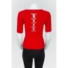 Red top with lacing on the back with a tag