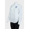 White shirt with blue embroidered brand logo