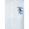 White shirt with blue embroidered brand logo