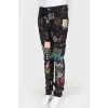 Black jeans with multi -colored drawings and inscriptions