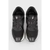 Black leather sneakers with lace and white soles