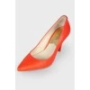 Red stiletto heeled pumps