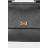 Black leather bag with golden fittings