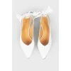 White leather shoes with a bow in the back