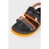 Black and orange sandals with a strap