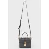 Black leather rectangular bag with a golden lock