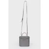 Grey leather bag with silver clasp, red leather inside