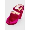 Purple suede high-heeled shoes with a tag