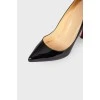 Black varnished stilettos, with red sole
