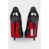 Black varnished stilettos, with red sole