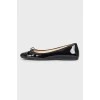 Black patent ballet flats with a bow