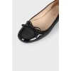 Black patent ballet flats with a bow