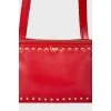 Red bag with gold rivets