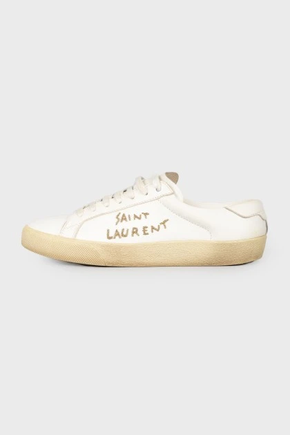 Leather sneakers with an embroidered brand's logo on the sides
