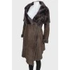 Sheepskin coat on fur with a wide collar